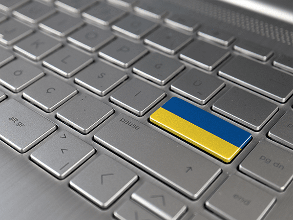 A grey keyboard with the "Enter" key in the colors of the Ukrainian flag.