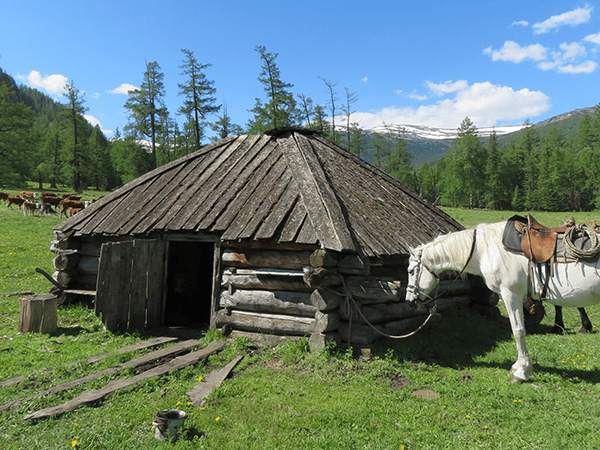 Image of a hut with a horse in front of it. Links to event page.