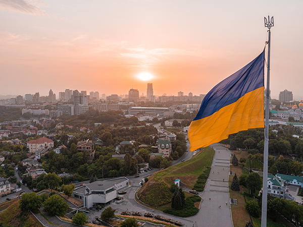 Ukrainian flag over sunset. Image links to event page.