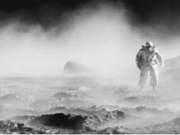 Black and white image of person in dusty environment. Image links to event page.