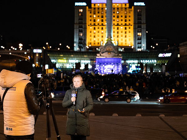 Reporter in a square in Ukraine. Image links to event page.