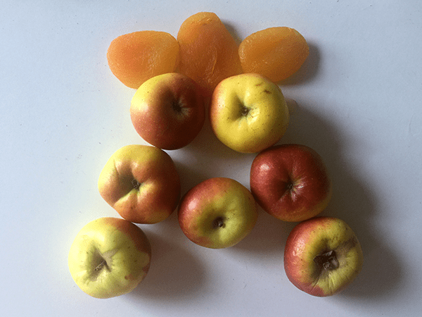 Apples and apricots arranged into the letter A.